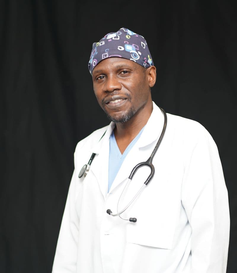 Dr. Keith Dindi in a white coat